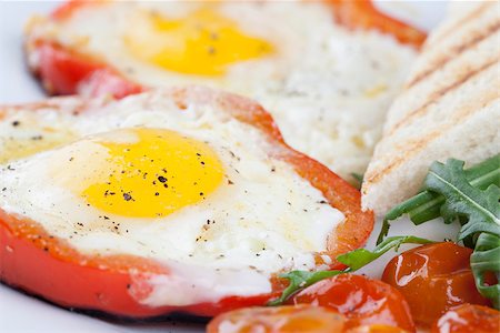fried egg and pepper - Eggs fired in bell pepper frames with cherry tomatoes and arugula Stock Photo - Budget Royalty-Free & Subscription, Code: 400-06747858