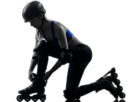 rollerblade girl - one caucasian woman tying roller skates  silhouette studio isolated on white background Stock Photo - Budget Royalty-Free & Subscription, Code: 400-06748283
