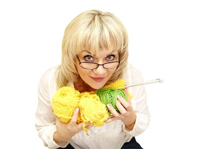 adult woman in glasses cuddle yarn and looking at the camera on a white background. isolated Stock Photo - Budget Royalty-Free & Subscription, Code: 400-06748324