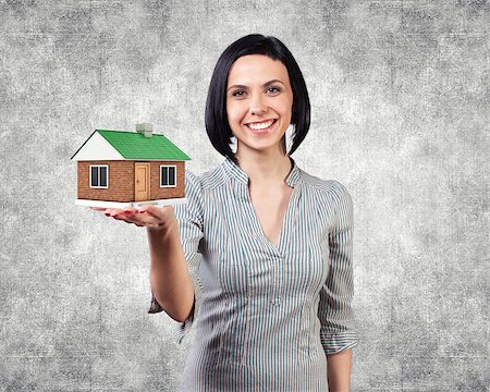 Photo of the girl with a house in a hand Stock Photo - Budget Royalty-Free & Subscription, Code: 400-06748398