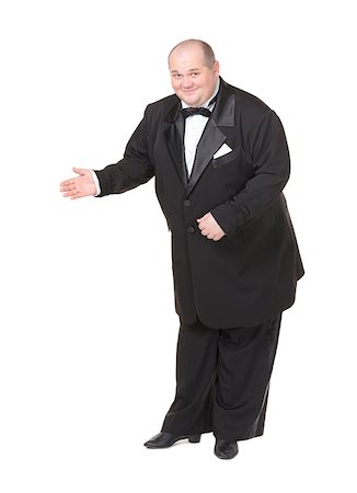 fat bald man in suits - Elegant fat man in a dinner jacket and bow tie smiling charmingly as he holds out his hand to the side gesturing in that direction Stock Photo - Budget Royalty-Free & Subscription, Code: 400-06748589