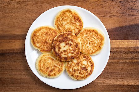 pancake top view - delicious traditional cheese pancakes in plate on wooden table Stock Photo - Budget Royalty-Free & Subscription, Code: 400-06748624