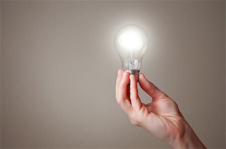 person holding energy efficient light bulb - Hand holding a glowing light bulb Stock Photo - Budget Royalty-Free & Subscription, Code: 400-06740147