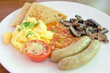 Sausages and Scrambled Eggs with Toast Baked Beans Mushroom and Tomato Breakfast Meal Stock Photo - Budget Royalty-Free & Subscription, Code: 400-06740694