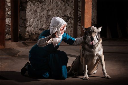 simsearch:400-06741212,k - Middle ages nun dog owner talking to her pet Photographie de stock - Aubaine LD & Abonnement, Code: 400-06741223