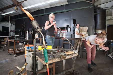 Distracted worker looking at co-worker from behind in glass factory Stock Photo - Budget Royalty-Free & Subscription, Code: 400-06741242