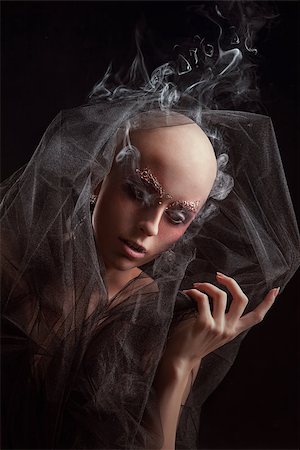 female elegant smokes - Model with a fake bald on black background Stock Photo - Budget Royalty-Free & Subscription, Code: 400-06742636