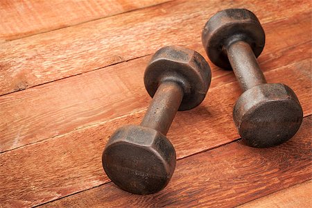 a pair of vintage iron rusty dumbbells on red barn wood background - fitness concept Stock Photo - Budget Royalty-Free & Subscription, Code: 400-06742888