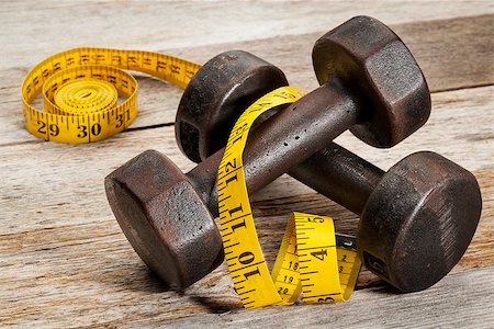 simsearch:400-07620929,k - a pair of vintage iron rusty dumbbells with yellow measuring tape on white painted barn wood background - fitness concept Stock Photo - Budget Royalty-Free & Subscription, Code: 400-06742889