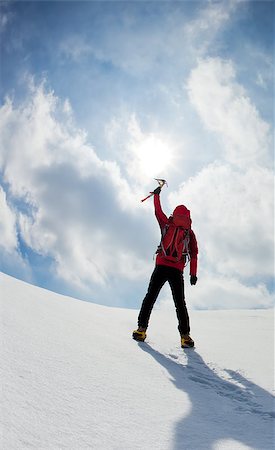 eispickel - Mountaineer walking uphill along a snowy slope. Rear view. Western Alps, Europe. Stockbilder - Microstock & Abonnement, Bildnummer: 400-06759067
