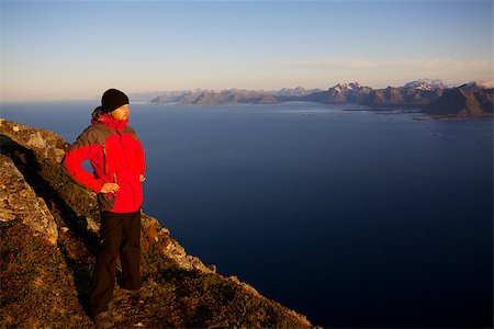 simsearch:400-07087598,k - Young man standing on the top of mountain Festvagtinden with picturesque scenery of Lofoten islands, Norway Stock Photo - Budget Royalty-Free & Subscription, Code: 400-06759327