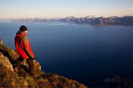 simsearch:400-07087598,k - Young man on the top of mountain Festvagtinden with picturesque scenery of chain of Lofoten islands, Norway Stock Photo - Budget Royalty-Free & Subscription, Code: 400-06759330