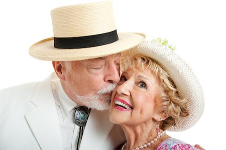 simsearch:400-08040653,k - Senior couple from the American South.  He's kissing her on the cheek.  White background. Stock Photo - Budget Royalty-Free & Subscription, Code: 400-06759379