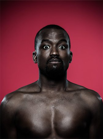one young dumb african man topless portrait in studio on red background Stock Photo - Budget Royalty-Free & Subscription, Code: 400-06750083