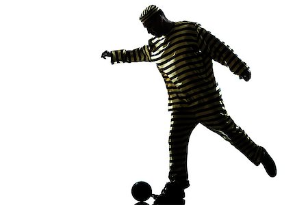 robber full body - one caucasian man prisoner criminal playing soccer with chain ball in studio isolated on white background Stock Photo - Budget Royalty-Free & Subscription, Code: 400-06750134