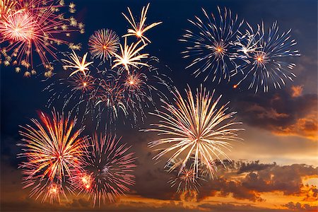 firework carnival - Beautiful colorful holiday fireworks in the evening sky with majestic clouds,  long exposure Stock Photo - Budget Royalty-Free & Subscription, Code: 400-06750789