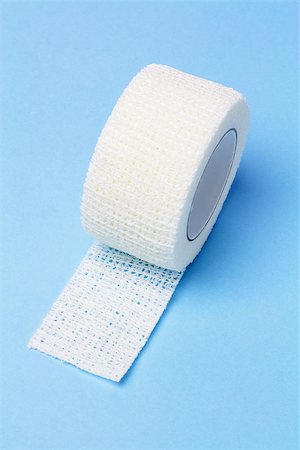 White Elastic Medical Bandage On Blue Background Foto de stock - Super Valor sin royalties y Suscripción, Código: 400-06751037