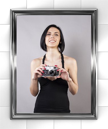 photographer mirror - Girl with camera is photographed before a mirror Stock Photo - Budget Royalty-Free & Subscription, Code: 400-06751295