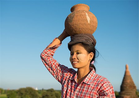 Portrait of Asian traditional female farmer carrying clay pot on head going back home, Bagan, Myanmar Stock Photo - Budget Royalty-Free & Subscription, Code: 400-06751638