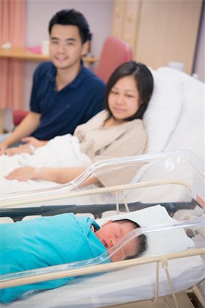 Asian Newborn Infant Baby Girl in Hospital Acrylic Bassinet with parents Stock Photo - Budget Royalty-Free & Subscription, Code: 400-06751645