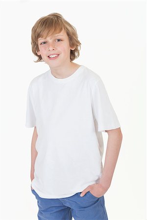 White background studio photograph of young happy boy smiling hands in pockets wearing blue denim jeans and white T-shirt Stock Photo - Budget Royalty-Free & Subscription, Code: 400-06751706