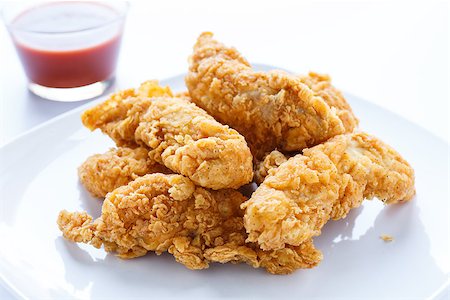 fried chicken plate - Fresh, fried chicken strips on a white plate in natural light Stock Photo - Budget Royalty-Free & Subscription, Code: 400-06751718