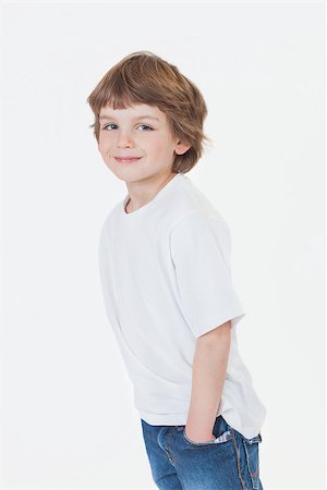 White background studio photograph of young happy boy smiling hands in pockets wearing blue denim jeans and white T-shirt Stock Photo - Budget Royalty-Free & Subscription, Code: 400-06751710