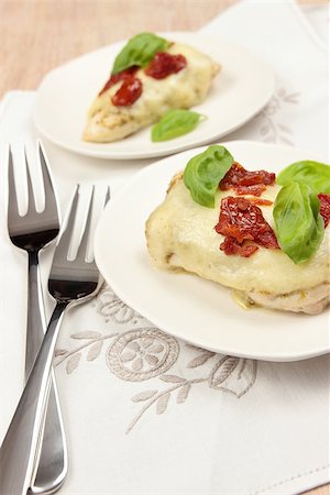 side dish with chicken - baked chicken with mozzarella, dried tomatoes and basil leaves Stock Photo - Budget Royalty-Free & Subscription, Code: 400-06751941