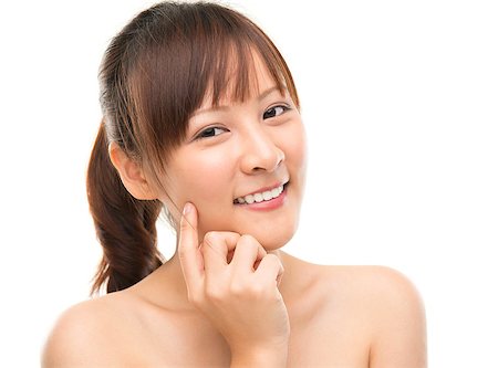 Skin care woman putting face cream touching her cheek. Facial beauty closeup of beautiful mixed race Asian female model isolated on white background. Stock Photo - Budget Royalty-Free & Subscription, Code: 400-06752016