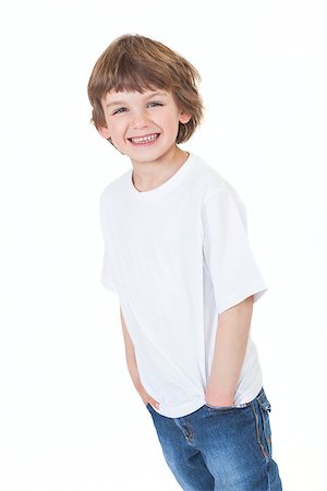 White background studio photograph of young happy boy smiling wearing blue denim jeans hands in pockets Stock Photo - Budget Royalty-Free & Subscription, Code: 400-06752045