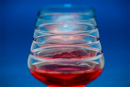 simsearch:400-05286682,k - Group of glasses filled with red wine over blue background. Stock Photo - Budget Royalty-Free & Subscription, Code: 400-06764468
