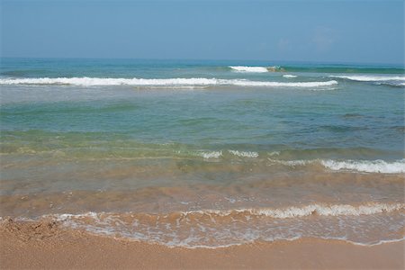 This ia an ocean coast. Gantle waves are beating against the shore. Fotografie stock - Microstock e Abbonamento, Codice: 400-06765215