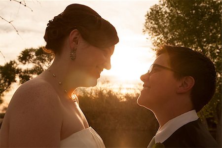Same sex female bride and groom outdoors by sunset Stock Photo - Budget Royalty-Free & Subscription, Code: 400-06765607