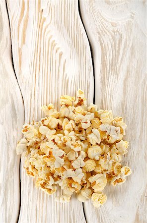 Heap popcorn on a white wooden table Stock Photo - Budget Royalty-Free & Subscription, Code: 400-06766080