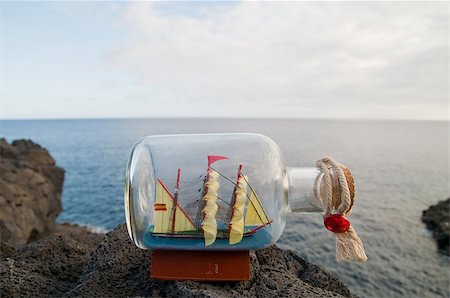 Vessel in a glass bottle on a rock near the atlantic ocean in Tenerife Stock Photo - Budget Royalty-Free & Subscription, Code: 400-06767121