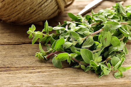 sprigs of oregano - fresh organic oregano (marjoram) on a wooden board Stock Photo - Budget Royalty-Free & Subscription, Code: 400-06767398