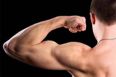 simsearch:400-03936805,k - strong biceps on a black background Photographie de stock - Aubaine LD & Abonnement, Code: 400-06767723