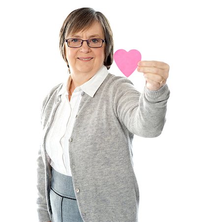 Female holding a pink paper heart, focus on the heart. Stock Photo - Budget Royalty-Free & Subscription, Code: 400-06768008
