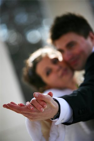 simsearch:400-04440941,k - Dance of a newly-married couple. Hands in a zone of sharpness, the rest is dim Fotografie stock - Microstock e Abbonamento, Codice: 400-06768113