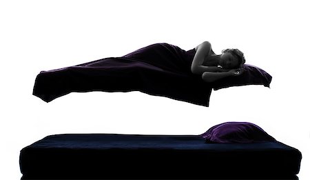 one woman sleeping in levitation on bed silhouette studio on white background Stock Photo - Budget Royalty-Free & Subscription, Code: 400-06768299