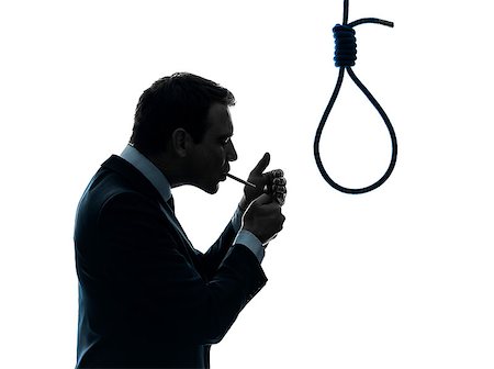 one caucasian man smoking cigarette  standing in front of hangman's noose in silhouette studio isolated on white background Stock Photo - Budget Royalty-Free & Subscription, Code: 400-06768383