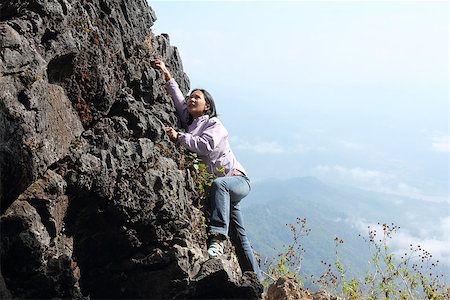 reach the mountaintop - Thai woman climbing rock Foto de stock - Super Valor sin royalties y Suscripción, Código: 400-06768922