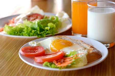 american style breakfast , with toast,  fried egg and fresh vegetables , milk and orange juice Stock Photo - Budget Royalty-Free & Subscription, Code: 400-06768964