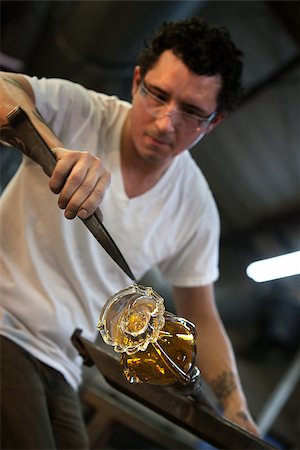 Worker pulling on edges of hot glass with large pliers Stock Photo - Budget Royalty-Free & Subscription, Code: 400-06768987