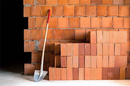 Brick wall with shovel, bucket and many bricks in a under construction masonry site Stock Photo - Budget Royalty-Free & Subscription, Code: 400-06769409