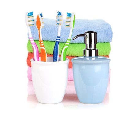 simsearch:400-04789848,k - Four colorful toothbrushes, liquid soap and towels. Isolated on white background Stock Photo - Budget Royalty-Free & Subscription, Code: 400-06769724