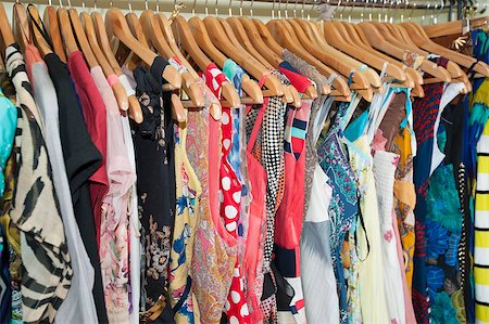 Various multi-colored items of clothing hanging on hangers and rail in a shop Stock Photo - Budget Royalty-Free & Subscription, Code: 400-06769785