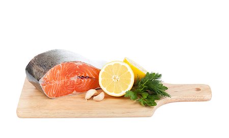 simsearch:633-01274958,k - Salmon on cutting board with lemons and herbs. Isolated on white background Photographie de stock - Aubaine LD & Abonnement, Code: 400-06769826