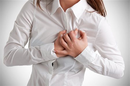 simsearch:400-03972278,k - Woman having a pain in the heart area Stock Photo - Budget Royalty-Free & Subscription, Code: 400-06769938