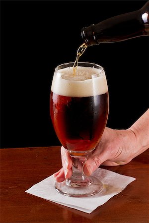 pouring an irish red ale beer into a chalice on a black background Stock Photo - Budget Royalty-Free & Subscription, Code: 400-06761022